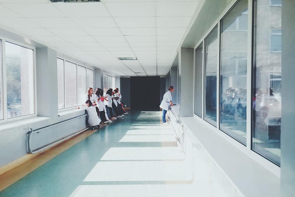 Group of medical professionals standing in hospital hallway