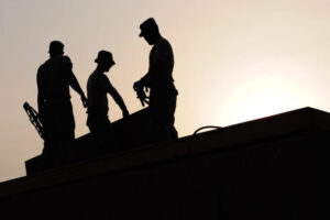 silhouette of three workers